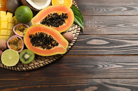 Fresh ripe papaya and other fruits on wooden table, above view. Space for textの写真素材