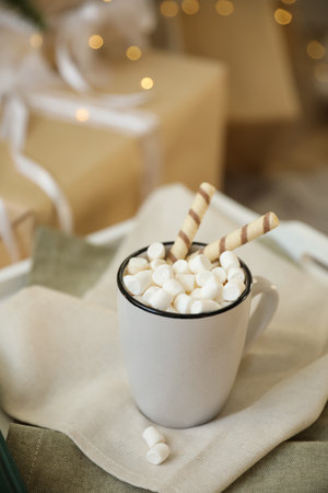 Cup of cocoa with wafer tubes on table indoors. christmas celebrationの写真素材