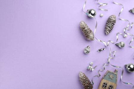 Flat lay composition with serpentine streamers and Christmas decor on violet background. Space for textの写真素材