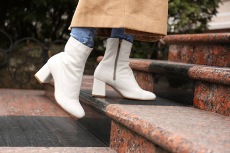 Woman wearing stylish leather shoes on stairs outdoors, closeupの写真素材