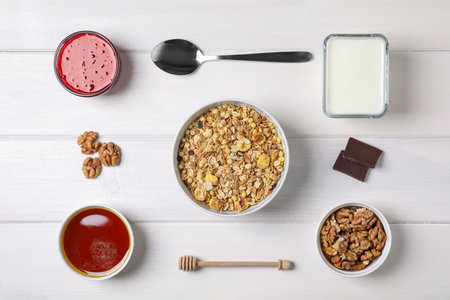 Flat lay composition with tasty muesli for breakfast on white wooden tableの写真素材