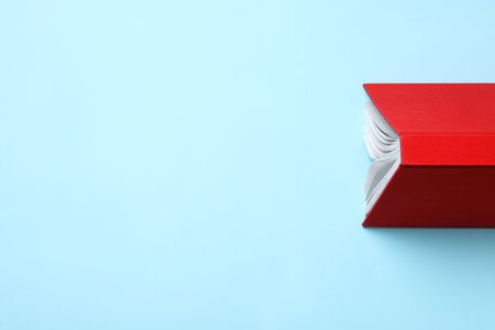Book with red over on turquoise background, top view. Space for textの写真素材