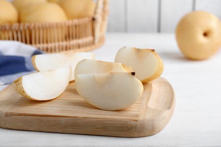 Slices of apple pear on white wooden tableの写真素材
