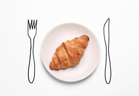 Plate with crispy croissant and drawn cutlery on white background, top viewの写真素材