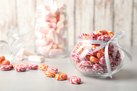 Delicious sweet candies on light grey tableの写真素材