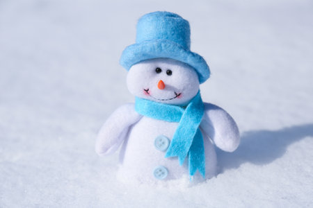 Cute small decorative snowman on snow outdoorsの写真素材