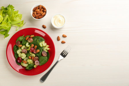 Delicious fresh celery salad served on white wooden table, flat lay. Space for textの写真素材