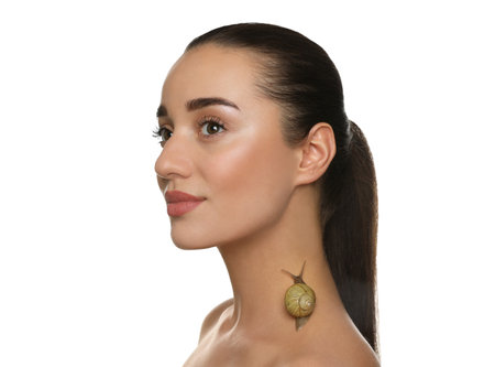Beautiful young woman with snail on her neck against white backgroundの写真素材