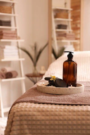 Beautiful spa accessories on massage table in roomの写真素材