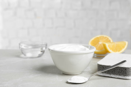 Baking soda and sponge on light gray tableの写真素材