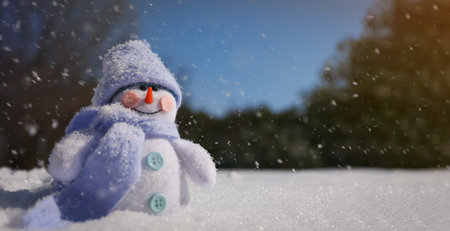 Cute small decorative snowman outdoors on winter day, space for textの写真素材