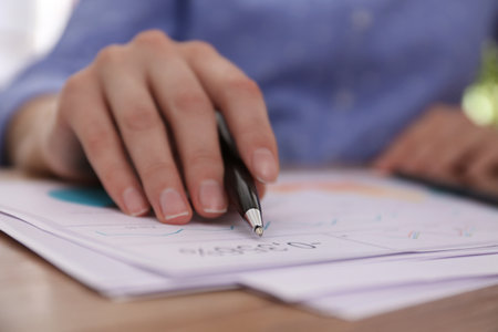 Businesswoman working with documents at table in office, closeup. investment analysisの写真素材