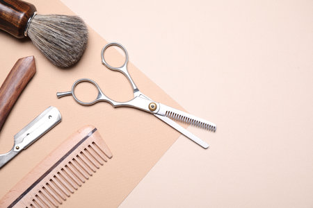 Set of barber's equipment on beige background, flat lay. Space for textの写真素材