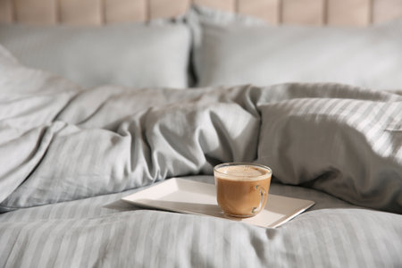 Tray with morning coffee on soft blanket. Space for textの写真素材