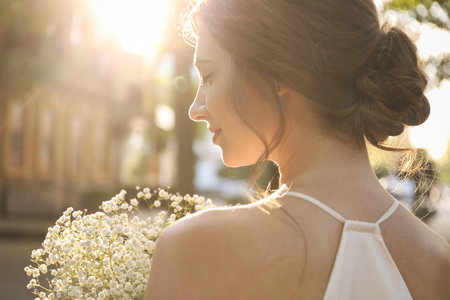 Bride in beautiful wedding dress with bouquet outdoors, closeupの写真素材