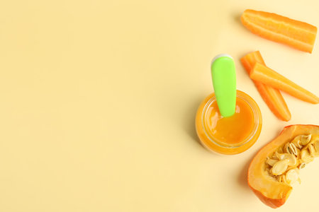Flat lay composition with healthy baby food and ingredients on beige background. Space for textの写真素材