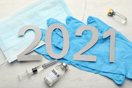Flat lay composition with coronavirus vaccine and number 2021 on white background