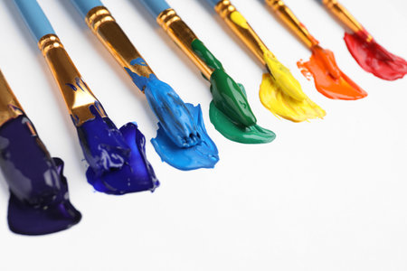 Set of brushes with different paints on white background, closeup. Rainbow colorsの写真素材