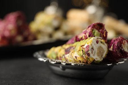 Tasty turkish delight dessert on dark table, closeup. Space for textの写真素材