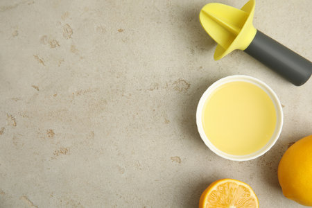 Freshly squeezed lemon juice on light grey table, flat lay. Space for textの写真素材