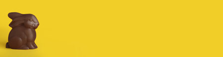 Chocolate bunny on yellow background, space for text. Easter celebrationの写真素材