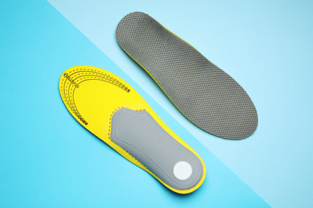 Orthopedic insoles on light blue background, flat layの写真素材