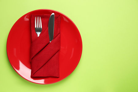 Stylish table setting on light green background, top viewの写真素材