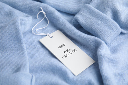 Warm light blue cashmere sweater with label, closeupの写真素材