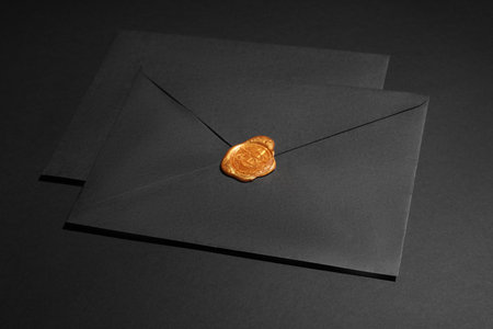 Envelopes with wax seal on black backgroundの写真素材