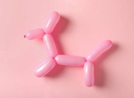 Dog figure made of modeling balloon on pink background, top viewの写真素材