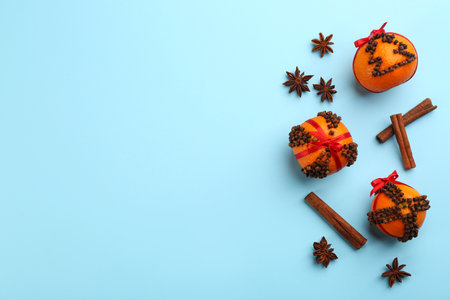Flat lay composition with pomander balls made of fresh tangerines on light blue background. Space for textの写真素材