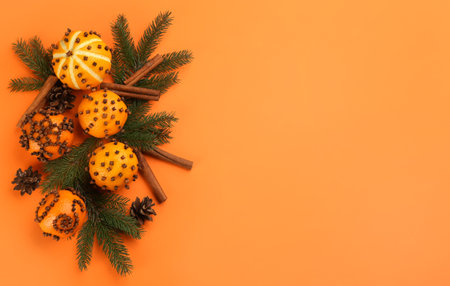 Flat lay composition with pomander balls made of fresh tangerines on orange background. Space for textの写真素材