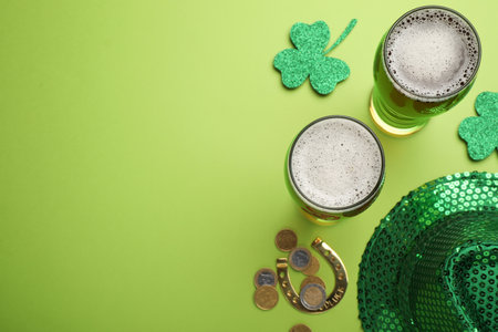 Beer, gold and St Patrick's Day decor on green background, flat lay. Space for textの写真素材