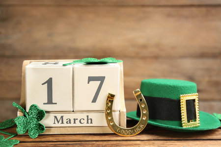 Composition with leprechaun hat and block calendar on wooden background. St Patrick's Day celebrationの写真素材