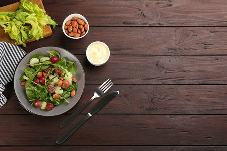 Delicious fresh celery salad served on wooden table, flat lay. Space for textの写真素材