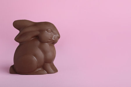 Chocolate bunny on pink background, space for text. easter celebrationの写真素材