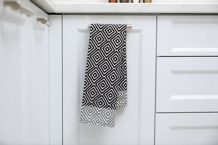 Clean towel on cabinet door in kitchenの写真素材