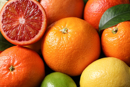 Different ripe citrus fruits as background, closeupの写真素材