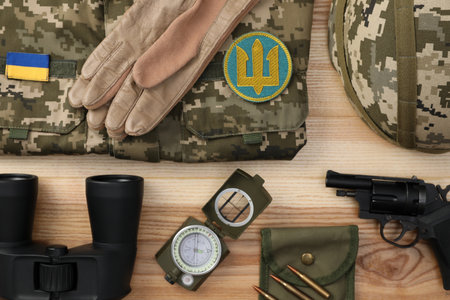 MYKOLAIV, UKRAINE - SEPTEMBER 26, 2020: Tactical gear, military uniform and Ukrainian army patches on table, flat layのeditorial素材
