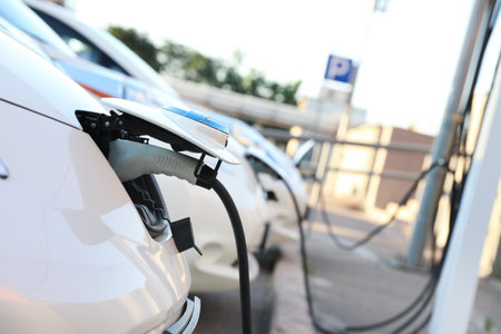 Charging modern electric cars from station outdoorsの写真素材