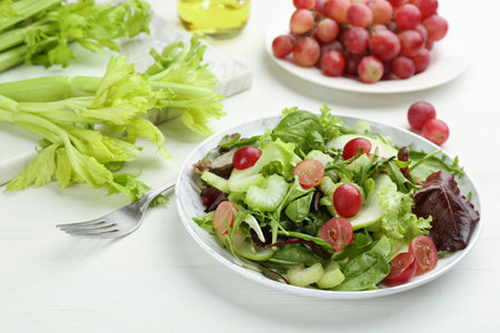 Delicious fresh celery salad on white wooden table, closeupの写真素材