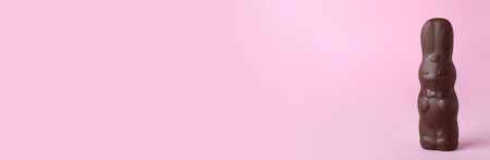 Chocolate bunny on pink background, space for text. easter celebration