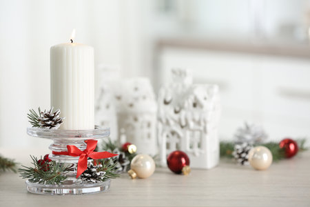 Christmas composition with glass candlestick on table in room. Space for textの写真素材