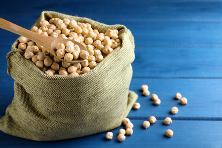 Raw chickpeas on blue wooden table, closeupの写真素材