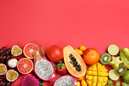 Many different delicious exotic fruits on red background, flat lay. Space for textの写真素材
