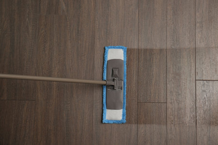 Cleaning of wooden floor with mop, top viewの写真素材