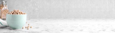 Chickpeas in bowl on white marble table, space for textの写真素材