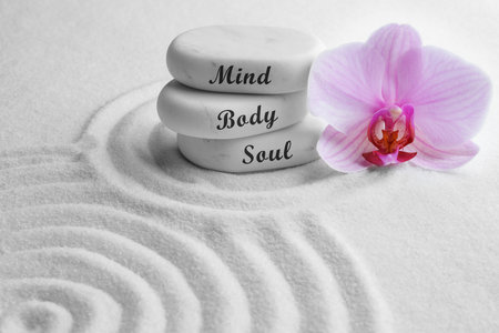 Stones with words Mind, Body, Soul and orchid on sand. Zen lifestyleの写真素材