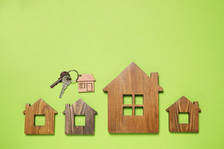 House models and keys on light green background, flat lay. Space for textの写真素材