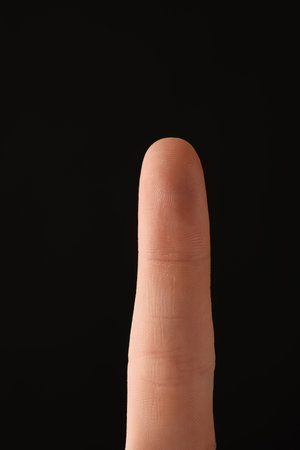 Man scanning fingerprint on black background, closeupの写真素材